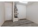Garage featuring concrete floor, water heater, and a white door leading to interior at 1609 Hills Of Red Dr # 104, Las Vegas, NV 89128