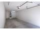 Spacious two car garage featuring concrete floor, water heater and lighting at 1609 Hills Of Red Dr # 104, Las Vegas, NV 89128