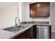 Kitchen sink featuring stainless steel appliances, granite countertops, and wooden cabinetry at 1609 Hills Of Red Dr # 104, Las Vegas, NV 89128