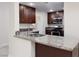 Modern kitchen featuring granite countertops and stainless steel appliances at 1609 Hills Of Red Dr # 104, Las Vegas, NV 89128