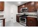 Well-equipped kitchen with modern appliances, granite countertops, and wooden cabinetry at 1609 Hills Of Red Dr # 104, Las Vegas, NV 89128
