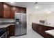 Bright kitchen featuring stainless steel appliances, granite countertops, and wooden cabinetry at 1609 Hills Of Red Dr # 104, Las Vegas, NV 89128
