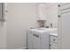Bright laundry room with a modern washer and dryer, and white cabinets at 1609 Hills Of Red Dr # 104, Las Vegas, NV 89128