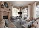 Bright and airy living room features fireplace, large windows, and comfortable seating at 1609 Hills Of Red Dr # 104, Las Vegas, NV 89128