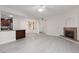 Open-concept living room featuring a fireplace, ceiling fan, and grey flooring at 1609 Hills Of Red Dr # 104, Las Vegas, NV 89128