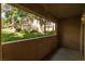 Patio view overlooking green spaces, mature trees, and lush landscaping at 1609 Hills Of Red Dr # 104, Las Vegas, NV 89128