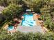 Aerial view of community pool and jacuzzi surrounded by lush landscaping, seating, and a gazebo at 1609 Hills Of Red Dr # 104, Las Vegas, NV 89128