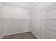 Bright walk-in closet features white walls, wire shelving, and stylish wood-look flooring at 1609 Hills Of Red Dr # 104, Las Vegas, NV 89128