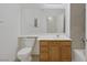 Bathroom features a wooden vanity and tile backsplash at 1830 N Buffalo Dr # 2024, Las Vegas, NV 89128