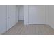 Bedroom featuring gray wood flooring and closet at 1830 N Buffalo Dr # 2024, Las Vegas, NV 89128