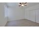 Bedroom featuring gray wood flooring, large window, and double door closet at 1830 N Buffalo Dr # 2024, Las Vegas, NV 89128