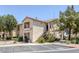 Attractive two-story condo building featuring beige stucco, a tile roof, and staircase access to upper units at 1830 N Buffalo Dr # 2024, Las Vegas, NV 89128
