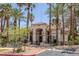 Exterior of community clubhouse surrounded by palm trees at 1830 N Buffalo Dr # 2024, Las Vegas, NV 89128