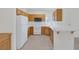 Functional kitchen with white appliances, tile countertops, and natural wood cabinetry at 1830 N Buffalo Dr # 2024, Las Vegas, NV 89128