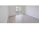 Bright living room with gray wood flooring and sliding doors to outdoor patio at 1830 N Buffalo Dr # 2024, Las Vegas, NV 89128