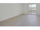 Bright living room with gray wood flooring and sliding doors to outdoor patio at 1830 N Buffalo Dr # 2024, Las Vegas, NV 89128