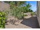 Landscaped backyard with gravel, trees, and partial shade at 2026 Wildwood Lake St, Henderson, NV 89052