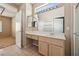 Neutral bathroom with modern vanity, large mirror, and adjacent shower at 2026 Wildwood Lake St, Henderson, NV 89052