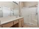 Bathroom featuring a double vanity and large glass shower at 2026 Wildwood Lake St, Henderson, NV 89052