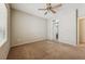 Neutral bedroom with carpet and ceiling fan overlooking ensuite bathroom at 2026 Wildwood Lake St, Henderson, NV 89052