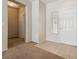 Bright foyer with neutral tones, tile and carpet flooring, and a white front door at 2026 Wildwood Lake St, Henderson, NV 89052