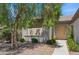 Inviting front entrance showcasing a tan door and neat landscaping with mature shade tree at 2026 Wildwood Lake St, Henderson, NV 89052