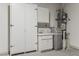 Garage interior featuring a storage area, work sink, and water heater at 2026 Wildwood Lake St, Henderson, NV 89052