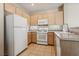 Kitchen featuring matching white appliances and tile floors at 2026 Wildwood Lake St, Henderson, NV 89052