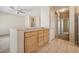 Open kitchen with wood cabinets and tile floors leads to entry hall at 2026 Wildwood Lake St, Henderson, NV 89052