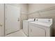 Practical laundry room featuring a washer, dryer, and shelving at 2026 Wildwood Lake St, Henderson, NV 89052