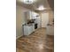Functional kitchen with white cabinetry, updated appliances, and wood-look flooring, creating a clean cooking area at 2120 Ramrod Ave # 417, Henderson, NV 89014