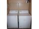 Functional laundry area with washer, dryer, and overhead shelf for convenience at 2120 Ramrod Ave # 417, Henderson, NV 89014