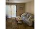 Cozy living room featuring neutral tones, plush seating, and sliding doors with natural light, designed for relaxation at 2120 Ramrod Ave # 417, Henderson, NV 89014