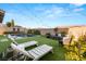 Serene backyard with a pool, sun loungers, comfortable seating, and privacy landscaping at 258 Castellari Dr, Las Vegas, NV 89138