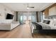 Bright main bedroom featuring hardwood floors, a sitting area, balcony access and stunning views at 258 Castellari Dr, Las Vegas, NV 89138