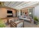 Cozy covered patio area with a tile floor, neutral furniture, and a ceiling fan at 258 Castellari Dr, Las Vegas, NV 89138