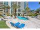 A luxurious community pool with poolside lounge chairs on a sunny day at 2777 Paradise Rd # 1002, Las Vegas, NV 89109