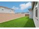 Backyard featuring artificial turf, block wall and view of surrounding homes at 3024 River Brook Ct, Las Vegas, NV 89139