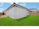 Lush backyard with artificial turf, a covered patio with privacy screen, and well-maintained landscaping at 3024 River Brook Ct, Las Vegas, NV 89139