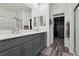 Modern bathroom featuring double sinks, sleek cabinetry, and a glass-enclosed shower at 3024 River Brook Ct, Las Vegas, NV 89139