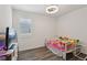 Bedroom with a colorful bed, natural light, and hardwood floors at 3024 River Brook Ct, Las Vegas, NV 89139