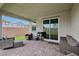 Inviting covered patio with brick flooring, comfortable seating, and a view of the landscaped backyard at 3024 River Brook Ct, Las Vegas, NV 89139