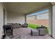Relaxing covered patio featuring brick flooring, comfortable seating, and a grill for outdoor enjoyment at 3024 River Brook Ct, Las Vegas, NV 89139