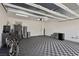 Bright and spacious garage with checkerboard flooring, storage, and a motorcycle parked inside at 3024 River Brook Ct, Las Vegas, NV 89139