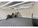 Spacious garage featuring a black and gray checkerboard floor, storage cabinets, and ample room at 3024 River Brook Ct, Las Vegas, NV 89139