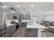 Well-lit kitchen with stainless steel appliances, an island, and an open layout to the living area at 3024 River Brook Ct, Las Vegas, NV 89139