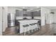 Modern kitchen boasts stainless steel appliances, gray cabinetry, and a center island with seating at 3024 River Brook Ct, Las Vegas, NV 89139