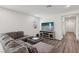 Comfortable living room features hardwood floors and a large sectional sofa at 3024 River Brook Ct, Las Vegas, NV 89139