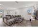 Bright and spacious living room with a large sectional couch, dining area, and plenty of natural light at 3024 River Brook Ct, Las Vegas, NV 89139