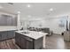 Bright open-concept living space with an island kitchen and comfortable seating area at 3024 River Brook Ct, Las Vegas, NV 89139